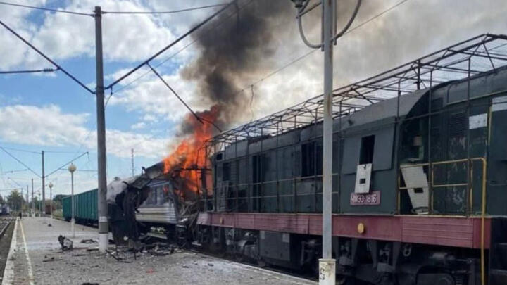 A Ukrainian passenger train is engulfed in flames after being hit by a Russian drone strike on a railway station in the Sumy region on October 4, 2025.