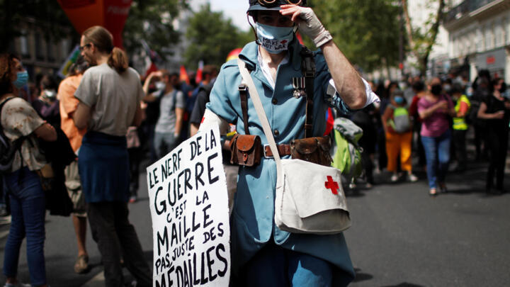 French health workers hailed, but enraged, on Bastille Day unlike any other