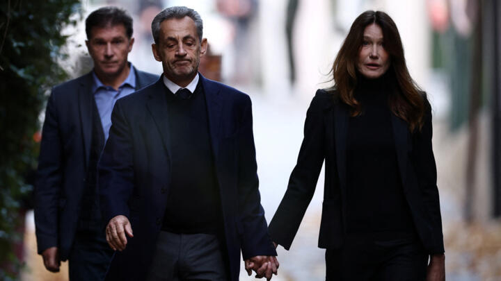 Former French President Nicolas Sarkozy leaves his house with his wife Carla Bruni-Sarkozy on October 21, 2025, the day of his incarceration.