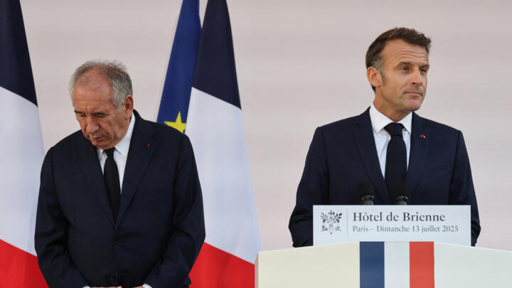 France's Prime Minister François Bayrou looks on as President Emmanuel Macron delivers a speech in Paris on July 13, 2025.