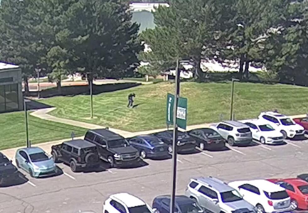 Screenshot taken from FBI video footage shows a suspect fleeing on the lawn at Utah Valley University in Orem.