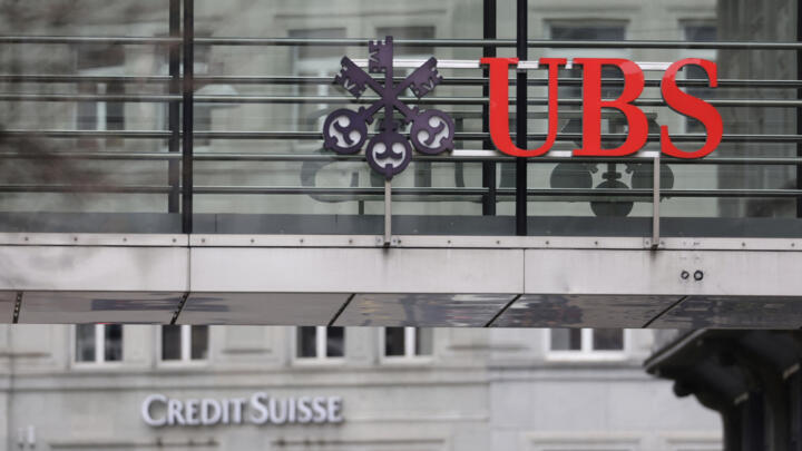 Logos of Swiss banks UBS and Credit Suisse are seen in Zurich, Switzerland on March 19, 2023.
