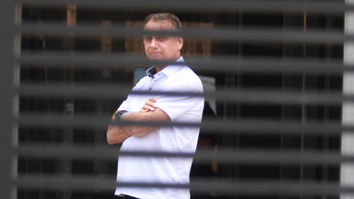 Brazil's former President Jair Bolsonaro stands at the entrance of his home where he is under house arrest in Brasilia, Brazil, Sept. 2, 2025.