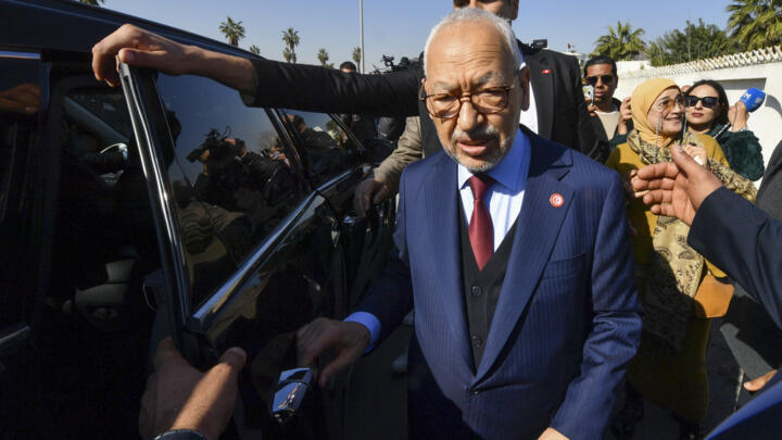 The head of Tunisia's Islamist movement Ennahdha Rached Ghannouchi greets supporters at a police station in Tunis, on February 21, 2023.