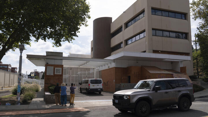 Volunteer immigration advocates document vehicles entering the US Immigration and Customs Enforcement (ICE) building on September 9, 2025, in Portland, Oregon.