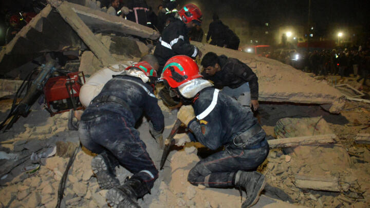 Emergency personnel search for victims in the rubble of a collapsed residential building in the Al Massira area of Fes late on December 9, 2025. 