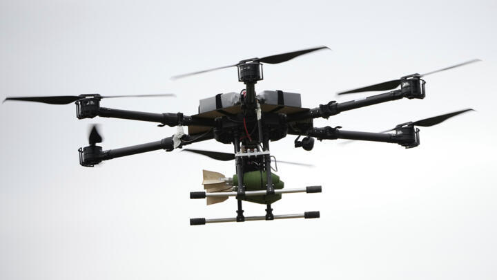 A drone carrying a bomb flies over during joint Russian-Belarusian military drills at a training ground near Barysaw, Belarus, Monday, Sept. 15, 2025.
