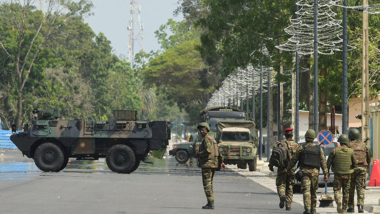 Soldiers patrol in front of the headquarters of Benin's radio and television station, in Cotonou, Benin.