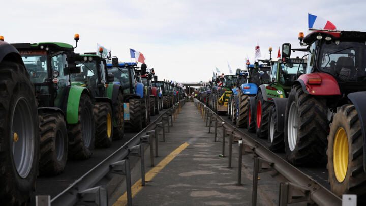 Tractors line up during a blockade by farmers on the A4 highway east of Paris on January 31, 2024.