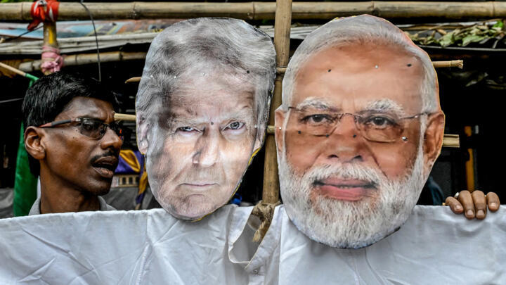 Congress activists carry an effigy of US President Donald Trump and Indian Prime Minister Narendra Modi as they protest against the Indo-US trade deal in Kolkata on August 1, 2025.