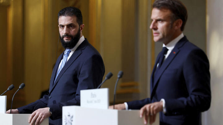 Syria's interim President Ahmad al-Sharaa, left, listens during a joint press conference with French President Emmanuel Macron after a meeting at the Elysee Palace in Paris, Wednesday, May 7, 2025.