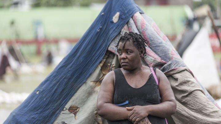 People gather after spending the night outside in the aftermath of the earthquake, facing the severe inclement weather of Tropical Storm Grace near Les Cayes, Haiti on August 17, 2021