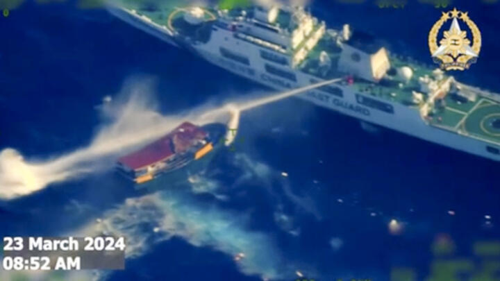 In this screen grab, a Chinese coast guard ship uses water cannons on a Philippine resupply vessel Unaizah May 4 as it approaches Second Thomas Shoal in the disputed South China Sea on March 23, 2024.