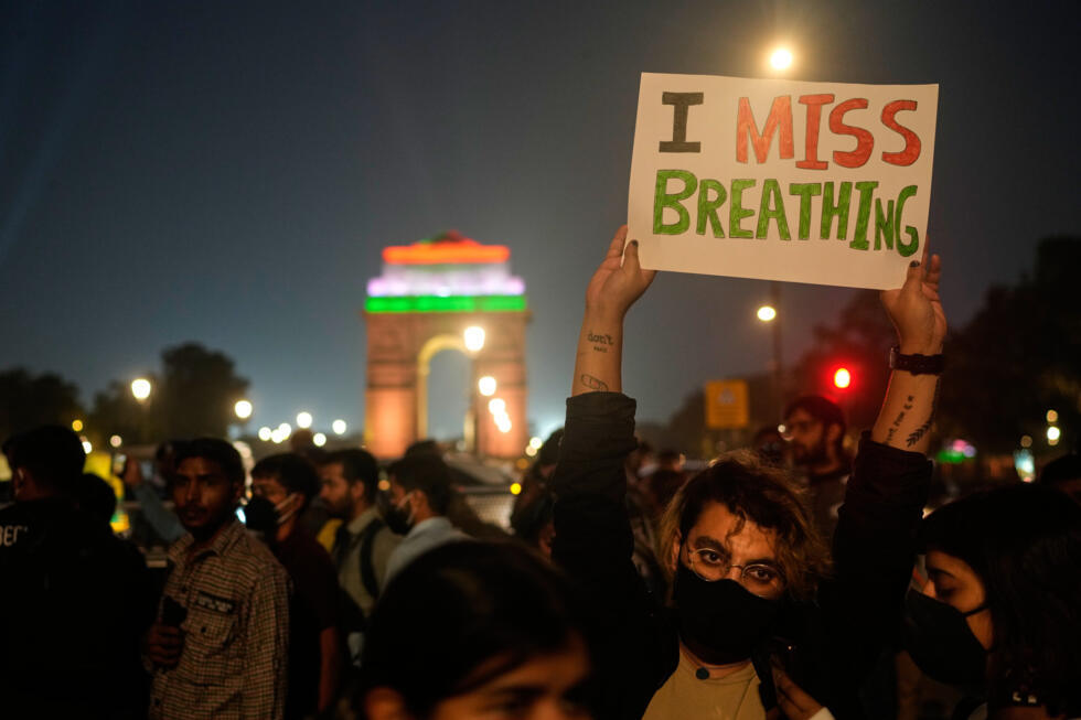A person holds a banner during citizens protest against what they called the government's lack of action to combat air pollution in the capital city New Delhi, India, Sunday, Nov. 9, 2025.
