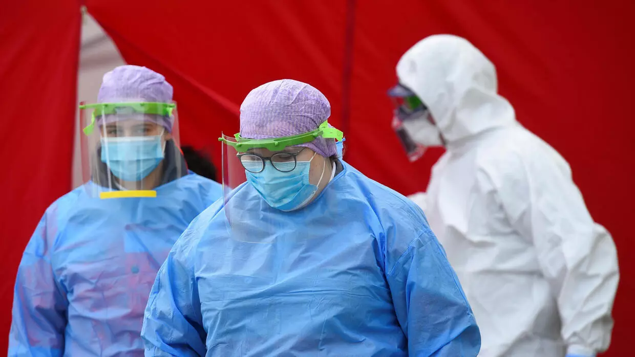 Medical employees wear protection gear at a newly opened drive-in corona special test center for Dresden public service employees such as police officers, nurses and firefighters, amid the spread of the coronavirus (Covid-19) in Dresden, eastern Germany, April 15, 2020.