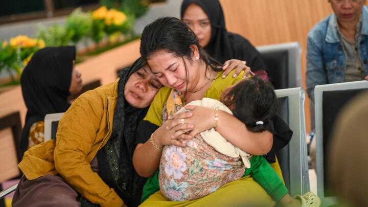 Family members wait for updates on the search operation of at least 61 people who were missing after a ferry sank off the Indonesian resort island of Bali on July 3, 2025.