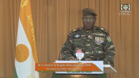 Niger's new military ruler General Abdourahamane Tiani reading a statement on national television on August 19, 2023.