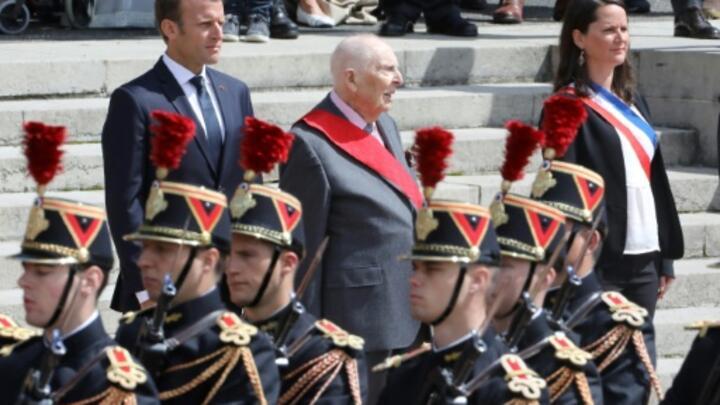 Daniel Cordier stands alongside French President Emmanuel Macron at the Mont Valérien Memorial on June 18, 2018.