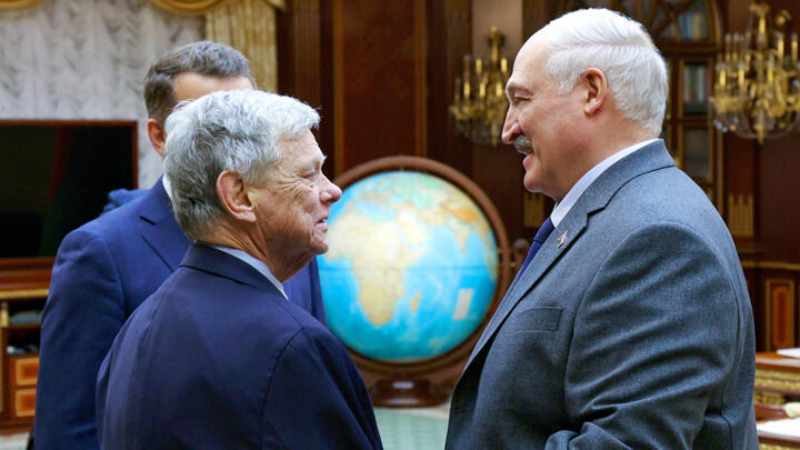 Belarusian President Alexander Lukashenko, right, and U.S. Presidential envoy John Coale shake hands during their meeting in Minsk, Belarus, on Friday, December 12, 2025