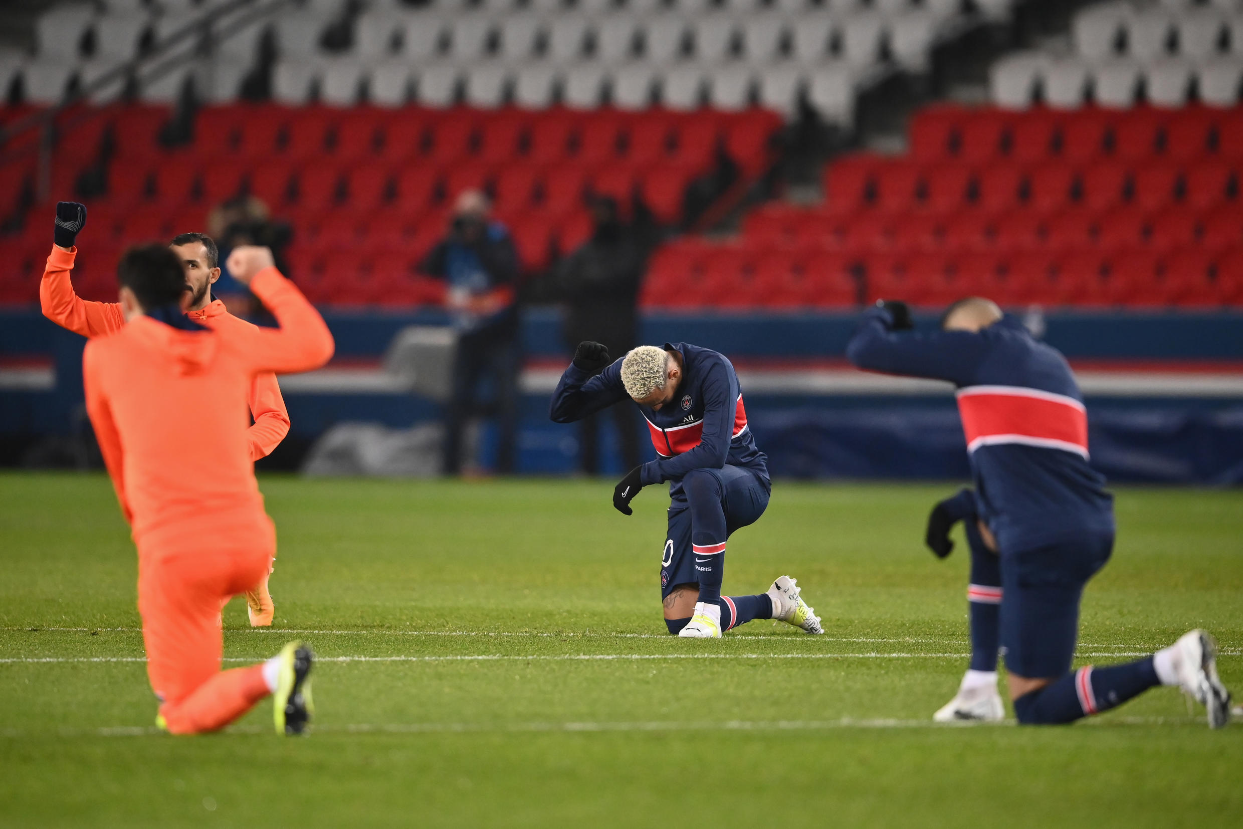 Brazilian forward Neymar (centre) and other players take a knee ahead of PSG's match against Istanbul Basaksehir FK at the Parc des Princes on December 9.