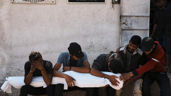 Palestinians mourn over the bodies of their relatives who were killed in an Israeli military strike on Gaza at Al-Shifa Hospital in Gaza City, Wednesday, June 4, 2025.