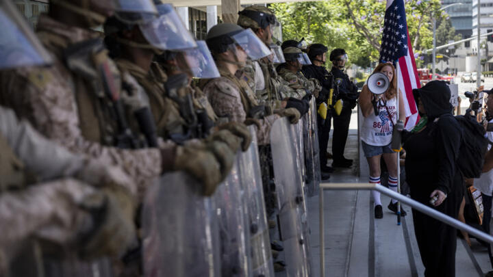 Demonstrators gather in front of the Federal building guarded by a mix of US marines and National guards, in Los Angeles, California on July 4, 2025.