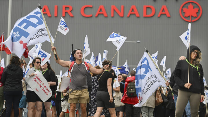 People protest outside Air Canada headquarters in Montreal, August 17, 2025.