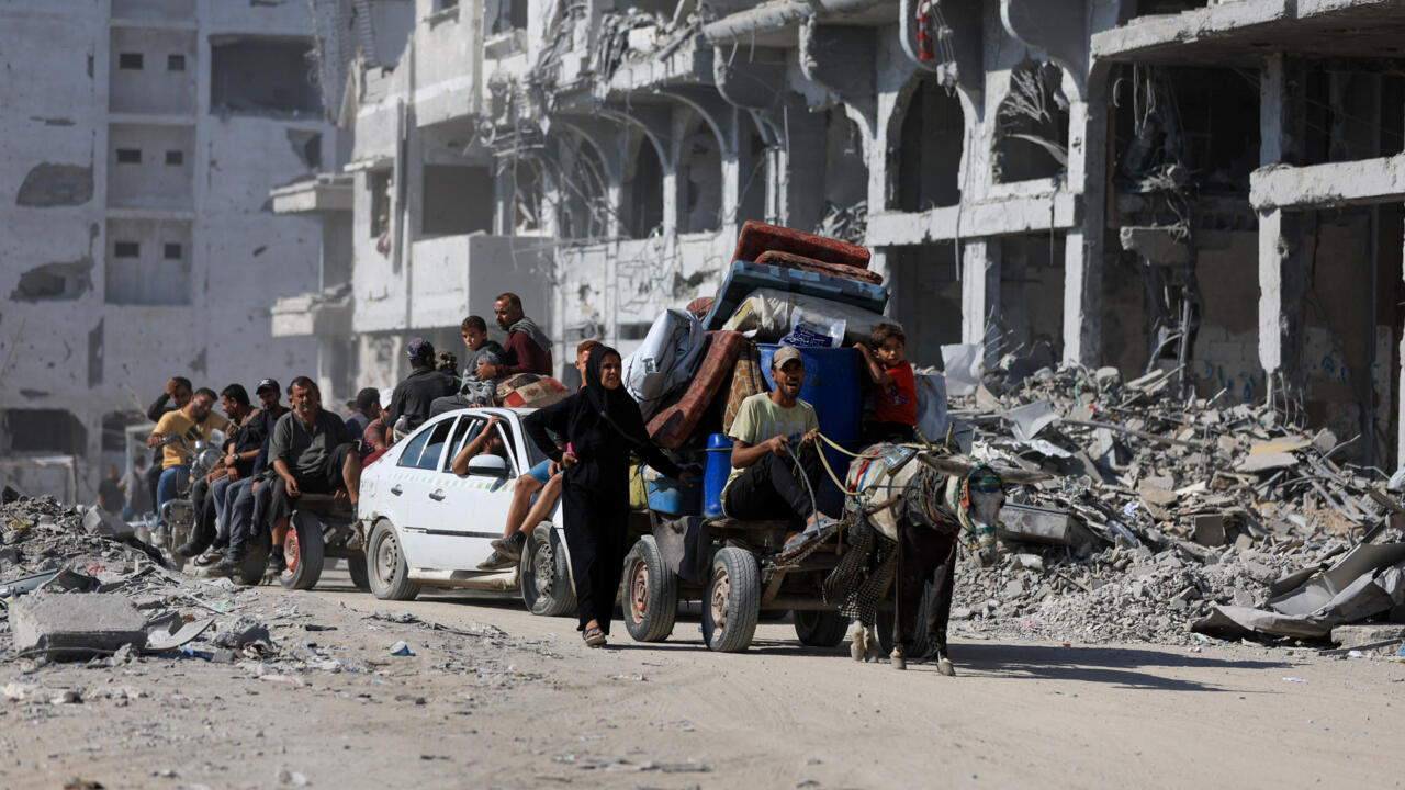 Palestinians ride on an animal-drawn cart past the rubble of destroyed buildings, amid a ceasefire between Israel and Hamas, in Gaza City, October 16, 2025.