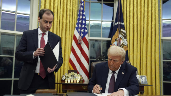 President Donald Trump signs an executive order regarding cartels in the Oval Office of the White House, January 20, 2025, in Washington.