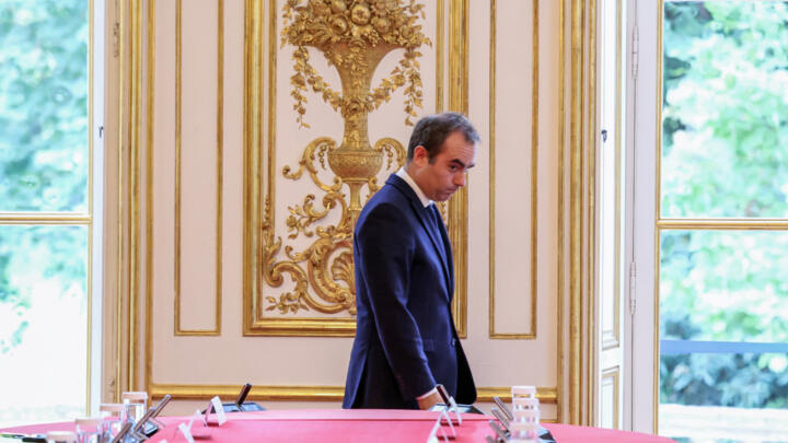 France's reappointed Prime Minister Sebastien Lecornu walks past a meeting table as he welcomes the newly-appointed members of his cabinet in Paris, Monday, Oct. 13, 2025.