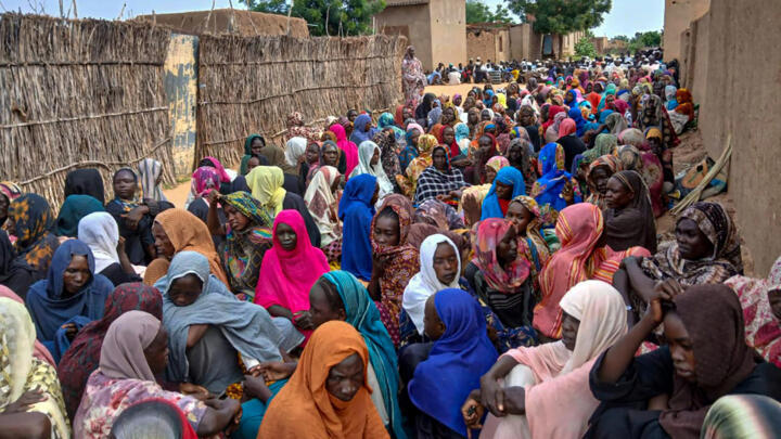 Sudanese residents gather to receive free meals in El-Fasher, a city besieged by Sudan's paramilitary Rapid Support Forces (RSF) for more than a year, in Darfur region, on August 11, 2025.