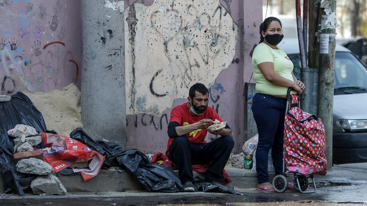 Un hombre come alimentos obtenidos en un comedor comunitario, en una villa de la Ciudad de Buenos Aires, Argentina el 30 de septiembre de 2020.