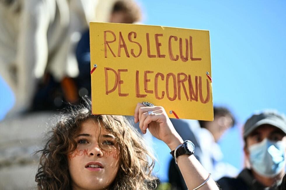 A protester holds a placard reading "enough of Lecornu" referring to newly appointed France's Prime Minister Sebastien Lecornu, during a demonstration  part of the "Bloquons tout".