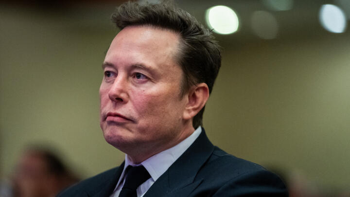 Elon Musk listens as US President-elect Donald Trump speaks during a House Republicans Conference meeting at the Hyatt Regency on Capitol Hill on November 13, 2024 in Washington, DC.