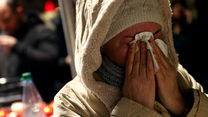 A mourner reacts during a vigil for the victims of a shooting in Hanau, near Frankfurt, Germany, February 20, 2020.