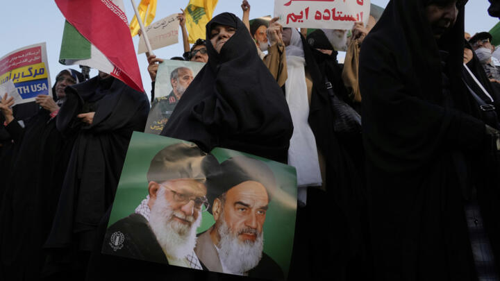 A poster of the founder of the Islamic Republic, Ayatollah Khomeini, and the Supreme Guide, Ayatollah Ali Khamenei, at an anti-American and anti-Israeli rally in Tehran on June 24, 2025.