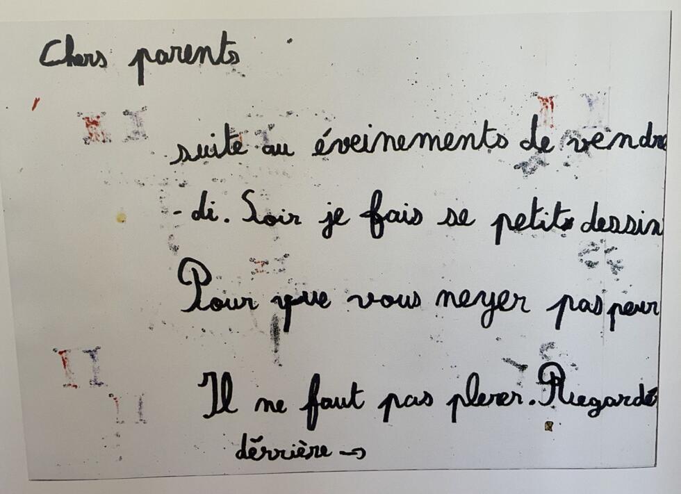 A child writes: 'Dear parents, following Friday night's events, I've drawn this picture so you won't be scared. Don't cry. Flip the page.'