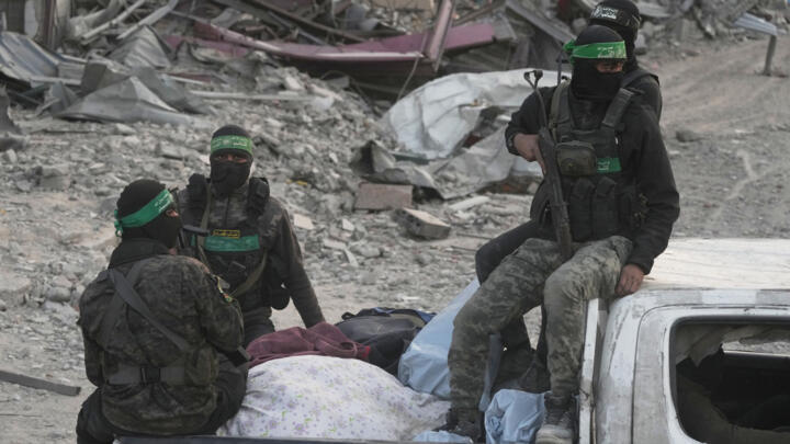 Hamas militants search for the bodies of hostages in the Shijaiyah neighbourhood of Gaza City on November 5, 2025.