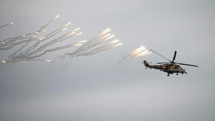 A helicopter gunship participates in joint Russian-Belarusian military drills at a training ground near Barysaw, Belarus, Monday, Sept. 15, 2025.