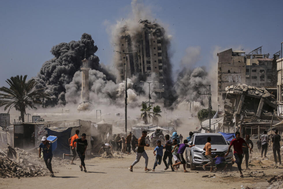 Los palestinos corren a refugiarse durante un ataque aéreo israelí contra un edificio de gran altura en la ciudad de Gaza, el viernes 5 de septiembre de 2025, después de que el ejército israelí emitiera una advertencia previa.