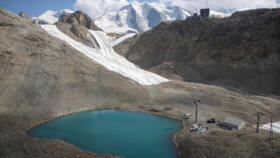 The last remaining snow from the winter season is seen on a slope beside the top station of a cablecar at Diavolezza ski area near the Alpine resort of Pontresina, Switzerland, July 21, 2022.