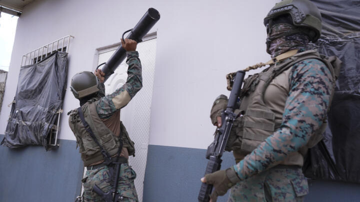 A soldier in Ecuador uses a battering ram to open a door during a joint operation with police to search for drugs in Guayaquil, Ecuador, on October 16, 2024.