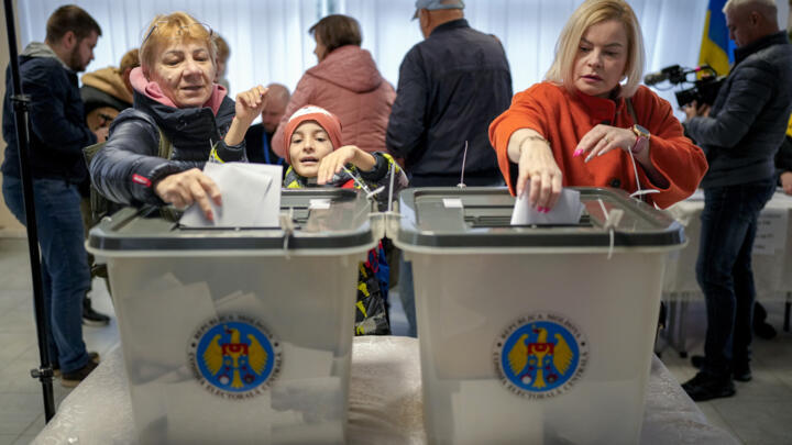 Women cast their vote in Chisinau, Moldova on October 20, 2024 during a presidential election and referendum.