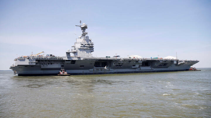 Pre-Commissioning Unit Gerald R. Ford (CVN 78) is maneuvered by tugboats in the James River during the aircraft carrier's turn ship evolution in Newport News, Virginia, US on June 11, 2016.