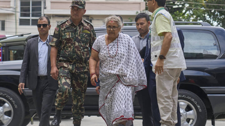 Nepal's interim prime minister Sushila Karki, center, arrives at Civil hospital to meet people injured during anti-corruption protests sparked by a short-lived social media ban in Kathmandu, Nepal, on