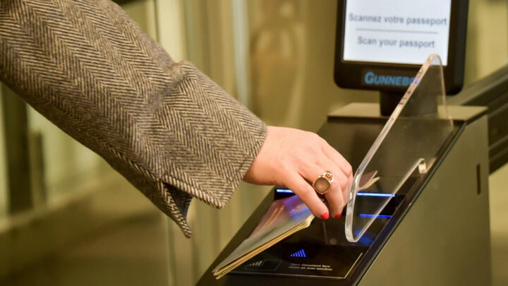 A woman passes her passport through security clearance before entering the Channel Tunnel on March 28, 2019, in Coquelles, France.