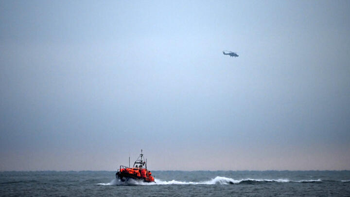 Migrants, picked up at sea attempting to cross the English Channel from France, are brought ashore on a Royal National Lifeboat Institution (RNLI) lifeboat on December 9, 2022. 