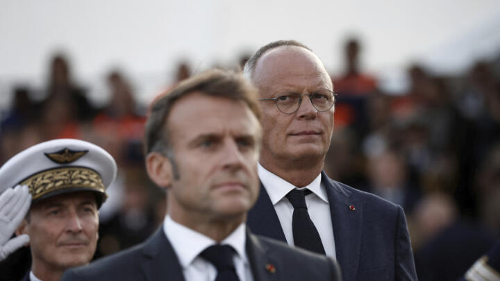 French President Emmanuel Macron (centre), and Le Havre Mayor Edouard Philippe (right) attend a ceremony commemorating the 80th anniversary of the liberation of the port city in western France.