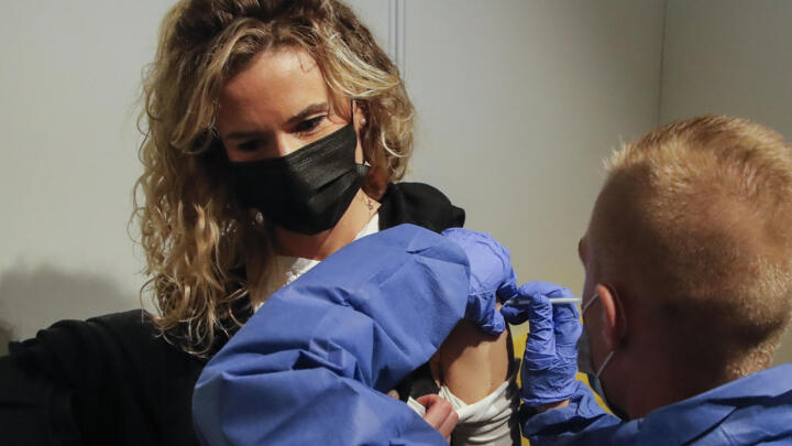 A woman receives a Pfizer COVID-19 vaccine at a new vaccination center run by the Paris' fire brigade in Paris, Thursday, May 6, 2021.