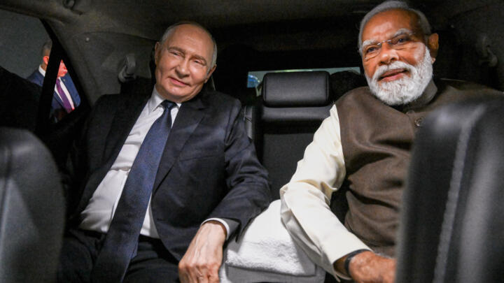 Russian President Vladimir Putin, and Indian Prime Minister Narendra Modi sit inside a limousine after arriving at the Palam Air Base in New Delhi, India, in December 2025.